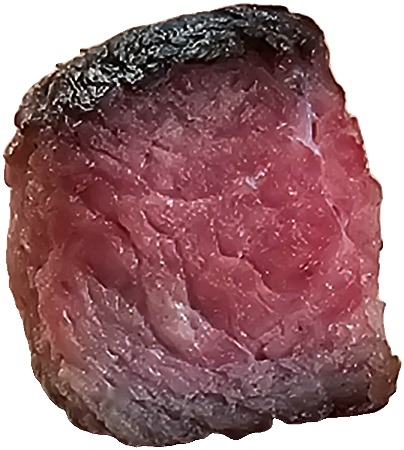 A cube of cooked Angus beef.