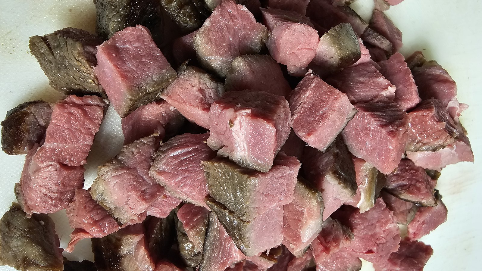 Cooked Angus beef, cut down by hand.